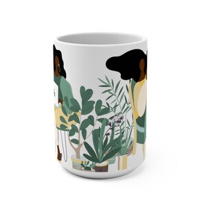May include: White ceramic mug with a colorful illustration of two women standing next to potted plants. The women have dark skin and are wearing green and yellow clothing. The plants are green and have pink flowers.
