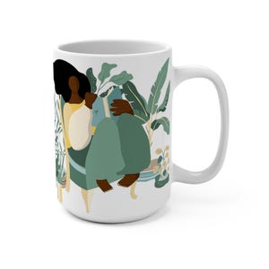 May include: White ceramic mug with a colorful illustration of a person sitting in a chair surrounded by plants and reading a book. The person has dark skin and is wearing a yellow shirt and green pants.