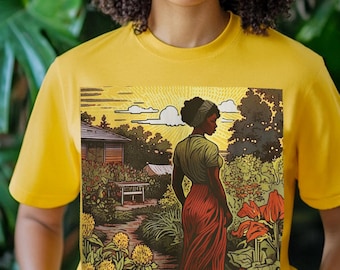 May include: Yellow t-shirt featuring a vibrant graphic of a woman in a garden. The artwork depicts a woman in a red skirt and green top, surrounded by flowers and a house. The shirt is a solid yellow color.