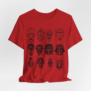 May include: Red t-shirt with a black and white print of 12 African tribal masks.