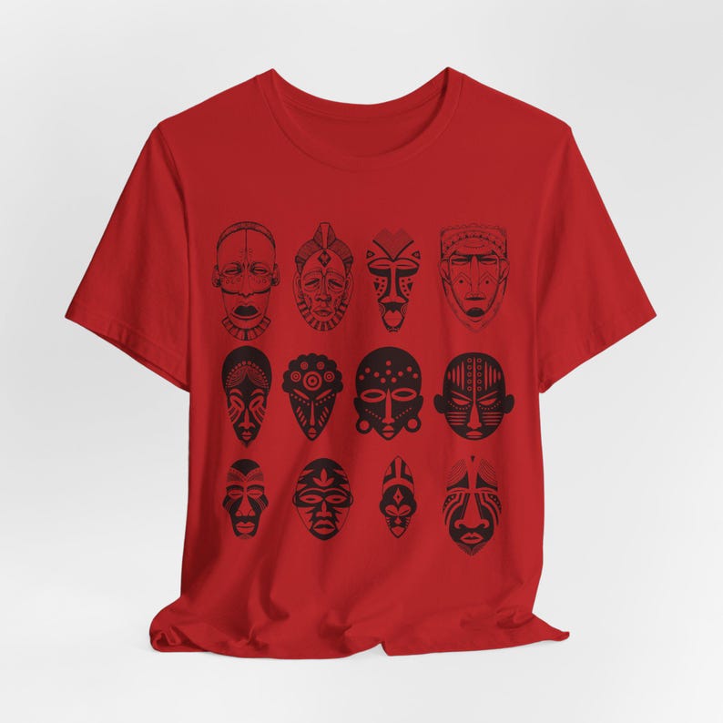 May include: Red t-shirt with a black and white print of 12 African tribal masks.
