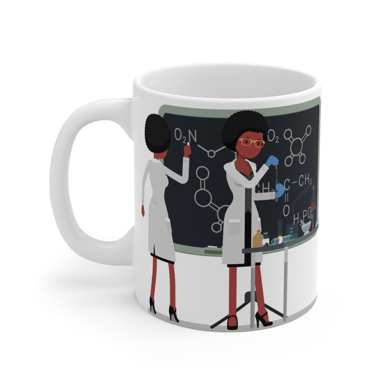 K&ouml;nnte beinhalten: Wei&szlig;e Keramiktasse mit einer Schwarzwei&szlig;illustration von zwei Frauen in Laborkitteln, die an einem Chemieexperiment arbeiten. Die Frauen sind schwarz und haben Afrofrisuren. Der Text auf der schwarzen Tafel hinter ihnen lautet "O2N, O2, CH3, C-CH3, O, H2PO4".