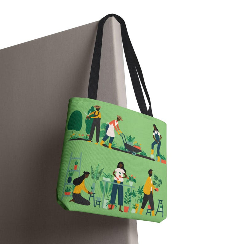 May include: Green tote bag featuring a garden scene with people gardening. The bag has black handles and a light green background. The illustration shows people working with plants, using tools, and tending to a garden.