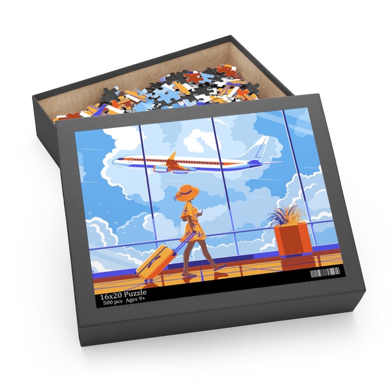 May include: A 500 piece jigsaw puzzle featuring a woman in a yellow dress and hat walking through an airport with a suitcase. The puzzle box shows a picture of the woman walking past a window with a plane flying overhead. The box says "16x20 Puzzle 500 pcs Ages 9+ "