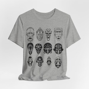 May include: A heather grey t-shirt with a black and white design of 12 African tribal masks.