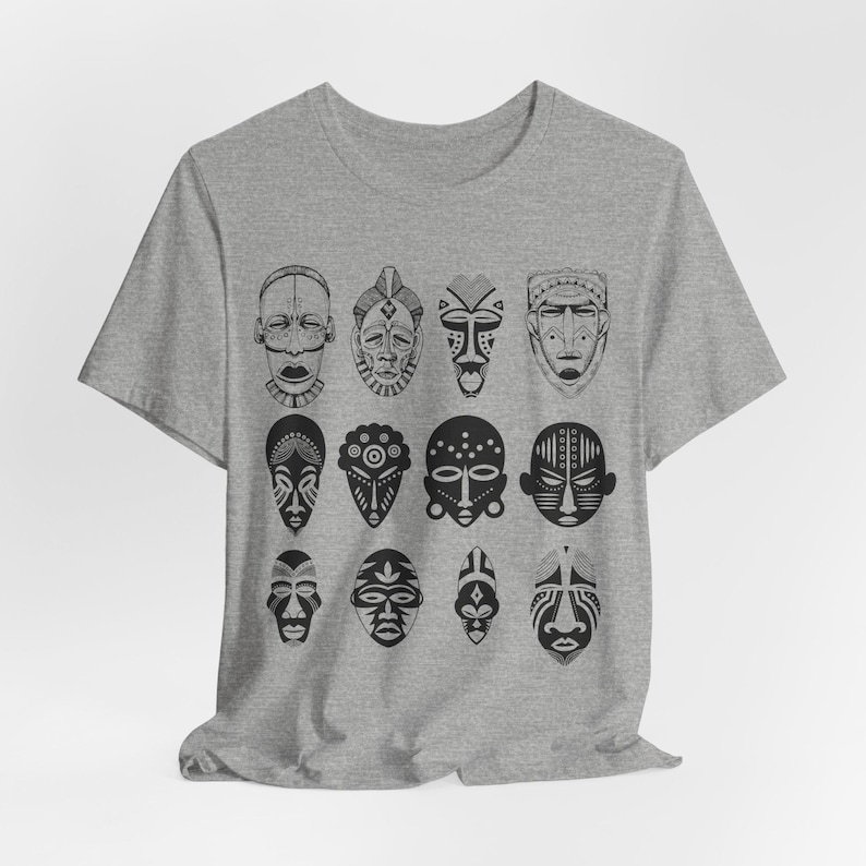 May include: A heather grey t-shirt with a black and white design of 12 African tribal masks.
