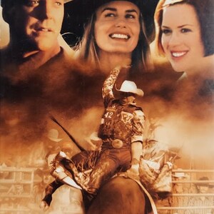 May include: A movie poster for the film "Cowboy Up" featuring actors Kiefer Sutherland, Daryl Hannah, and Molly Ringwald. The poster features a rodeo scene with a cowboy riding a bucking bull. The text "This isn't sport... this is WAR!" is at the bottom of the poster.