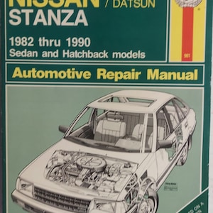 May include: A green and yellow Haynes Automotive Repair Manual for a Nissan Stanza, covering models from 1982 to 1990. The cover features a line drawing of a white Nissan Stanza with the hood open, revealing the engine.