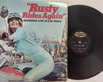 Vintage 1967 Vinyl Record Comedy Album by Rusty Warren titled Rusty Rides Again