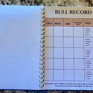 May include: A spiral-bound notebook open to a page titled BULL RECORD. The page features a table with columns for TAG #, BREED, DOB, PURCHASE DATE, STATUS, and NOTES. The status column includes checkboxes for Active, Retired, Sold, and Cull.