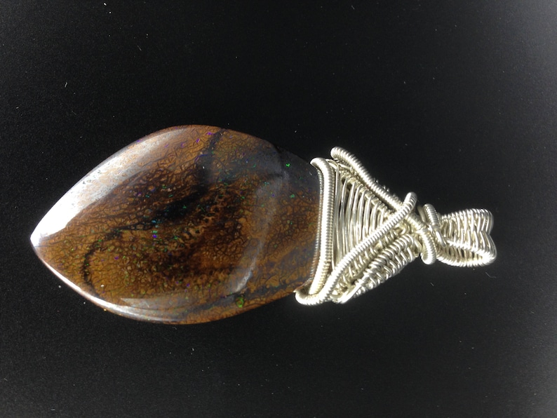 both sides Matrix boulder opal set in a wire wrapped silver pendant