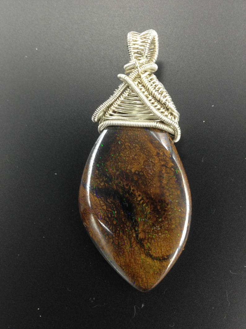 both sides Matrix boulder opal set in a wire wrapped silver pendant