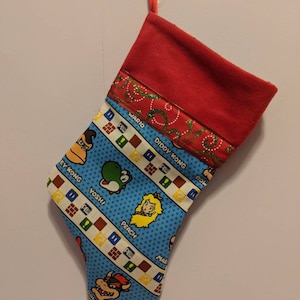 Mario/ Princesa Peach/ 8 bytes/ Monedas/ Luigi/ Bowser/ Wario/ Yoshi/ Donkey Kong/ Daisy/ Hongos/ Medias/ Navidad/ Nerd/ Donkey Kong