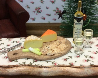 A miniature rustic cheeseboard, featuring Pave d'Auge washed rind cheese and Port Salut, with celery, a selection of biscuits and Ice-wine.