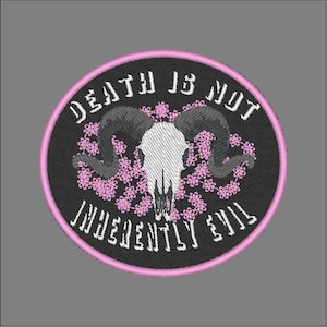May include: Black and white embroidered patch featuring a skull with horns surrounded by pink flowers. The text "DEATH IS NOT INHERENTLY EVIL" is written in a white, gothic font around the skull.