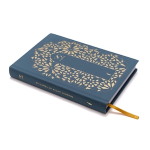 May include: A teal-colored journal with gold geometric patterns and the text "99 Names of Allah Journal." The journal has a gold ribbon bookmark. The cover features a gold geometric design.
