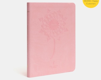 May include: A pink journal with an embossed design of a flower with a geometric pattern. The journal has the text "Ramadan Journal" on the spine.