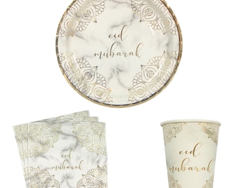 May include: A set of disposable party supplies featuring a marble and gold design with the text "Eid Mubarak". The set includes a large round paper plate, a small paper cup, and four square paper napkins.