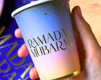 May include: A set of five handmade ceramic mugs in various colors: light blue, dark blue, green, yellow, and orange. Each mug has a unique shape and a glossy finish, perfect for coffee or tea.