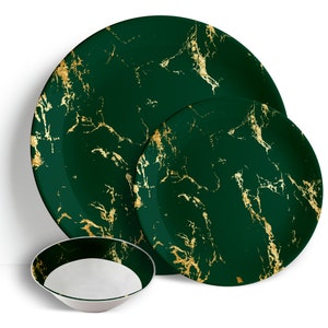 May include: A set of three green and gold marble-patterned dinnerware plates. The set includes a large dinner plate, a smaller salad plate, and a bowl.