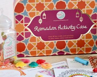 May include: A colorful Ramadan Activity Case with a geometric pattern, a jar of Halal sweets, and craft supplies. The case features the text "Ramadan Activity Case" and "Over 40 fun crafts and activities".