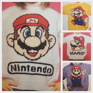 May include: A collection of knitted sweaters featuring the character Mario from the Nintendo video game series. The sweaters are white, yellow, and purple, with Mario's face and the word "Nintendo" or "Mario" displayed prominently. The sweaters are designed for children.