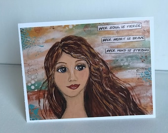 May include: A painting of a woman with long brown hair and blue eyes. The background is a colorful abstract design. The text "Her soul is fierce, Her heart is brave, Her mind is strong" is written in a banner across the top of the image.