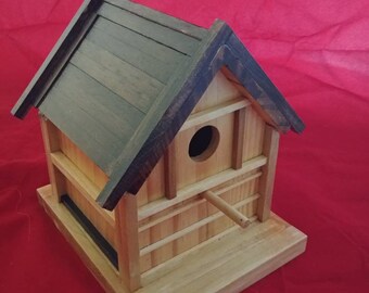 Classic wooden birdhouse for wrens and sparrows.