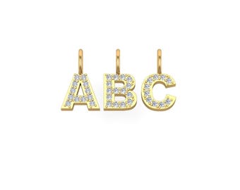 May include: Three gold charms in the shape of the letters A, B, and C. Each letter is covered in small, clear crystals.