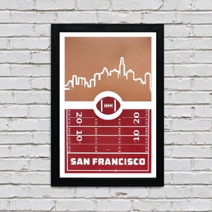May include: A red and brown poster with a white outline of the San Francisco skyline. The poster features a football field with yard lines and a football in the center. The text "SAN FRANCISCO" is printed at the bottom of the poster.