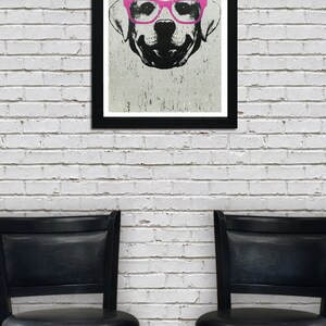 May include: A black and white illustration of a dog wearing pink glasses. The illustration is framed and hanging on a white brick wall. Two black bar stools are in front of the wall.