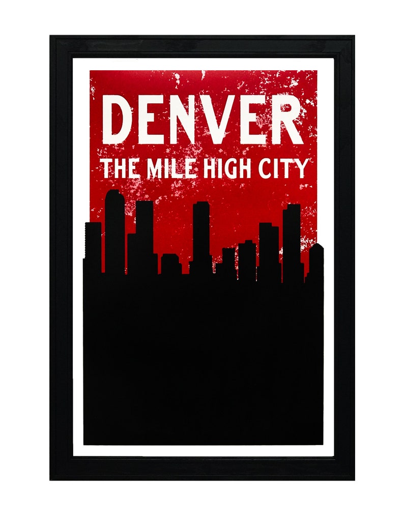 May include: Framed art print featuring the word "DENVER" in white capital letters above the text "THE MILE HIGH CITY" on a distressed red background. A black silhouette of a city skyline is at the bottom.