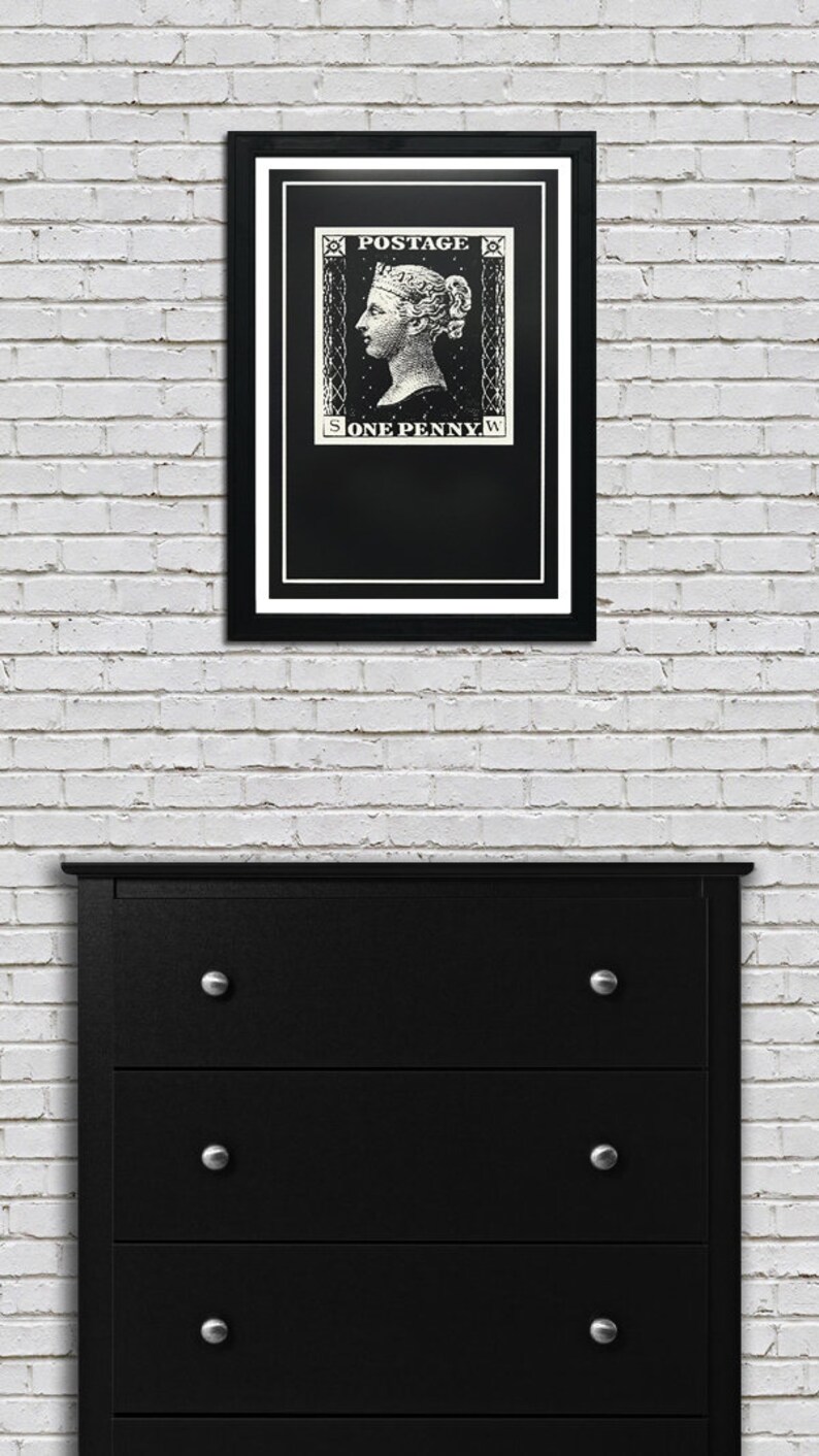 May include: A black and white framed print of a vintage postage stamp featuring a woman's profile and the text "POSTAGE ONE PENNY".