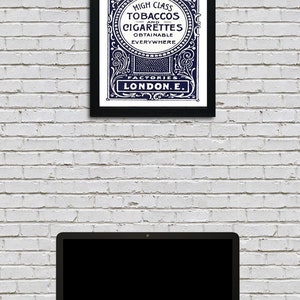 May include: A vintage advertisement for Harris & Sons high class tobaccos and cigarettes, featuring an ornate blue and white design with the text "Factories London E."