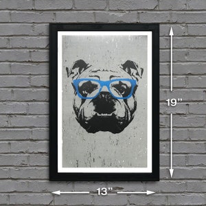 May include: A black and white illustration of a bulldog wearing blue glasses. The image is printed on a textured, gray background. The print is framed in a black frame and measures 13 inches wide by 19 inches tall.
