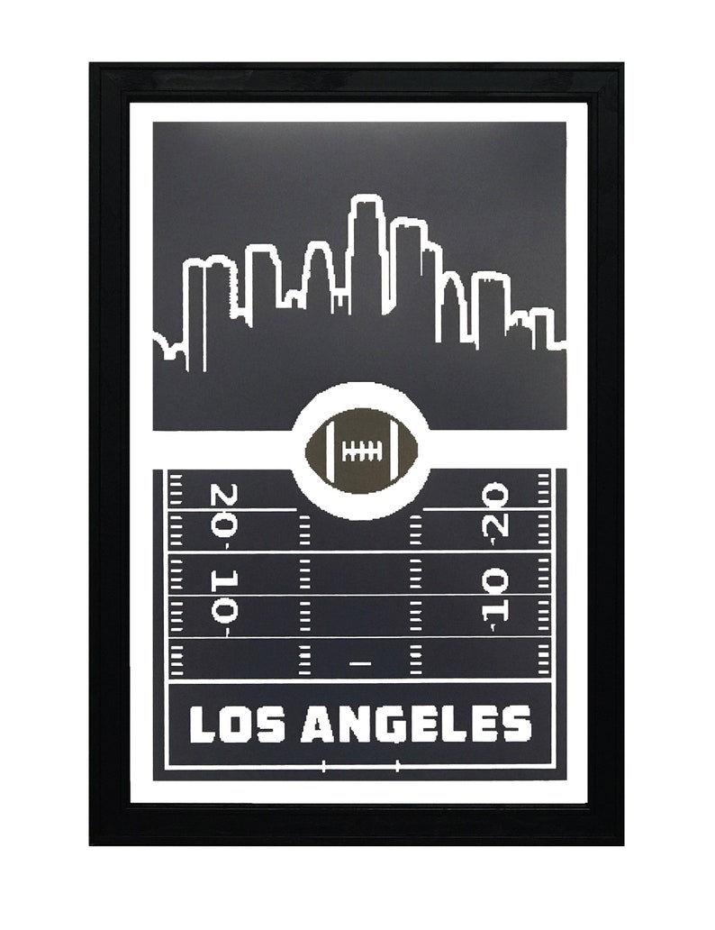 May include: Black and white framed print of a football field with a Los Angeles skyline and the text "LOS ANGELES" at the bottom.
