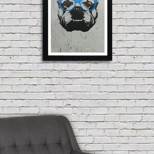 May include: A black and white illustration of a bulldog wearing blue glasses. The illustration is printed on a white background and framed in a black frame.