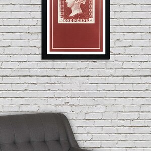 May include: A framed print of a vintage postage stamp featuring a profile of Queen Victoria with the text "POSTAGE" and "ONE PENNY" in white on a red background.