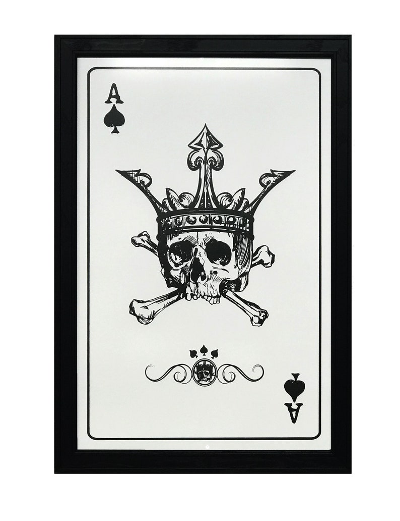 May include: A black and white illustration of the Ace of Spades playing card. The card features a skull wearing a crown and crossed bones. The card is framed in a black frame.