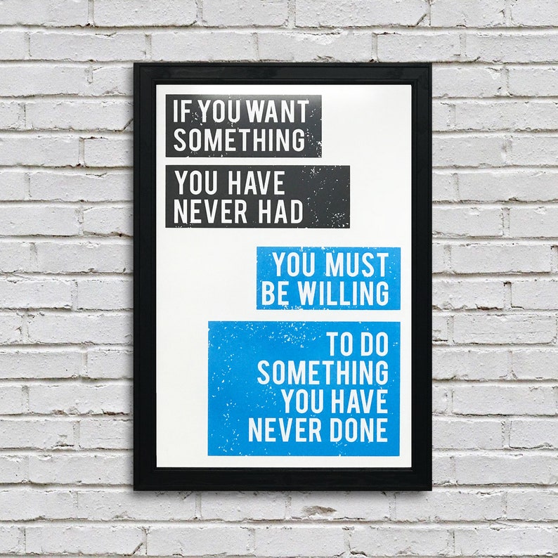 May include: A motivational quote poster with a black frame and white background. The quote reads: "If you want something you have never had, you must be willing to do something you have never done."