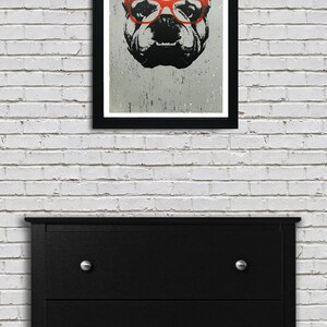 May include: A black and white illustration of a bulldog wearing red glasses. The image is printed on a textured background and framed in a black frame.