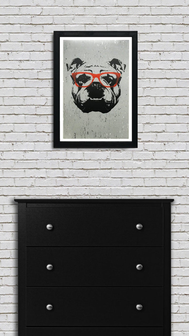 May include: A black and white illustration of a bulldog wearing red glasses. The image is printed on a textured background and framed in a black frame.