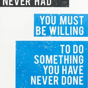 May include: Blue and white motivational quote poster with the text "You must be willing to do something you have never done."
