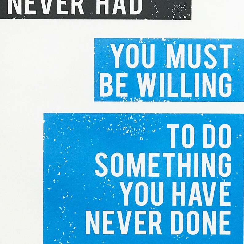 May include: Blue and white motivational quote poster with the text "You must be willing to do something you have never done."