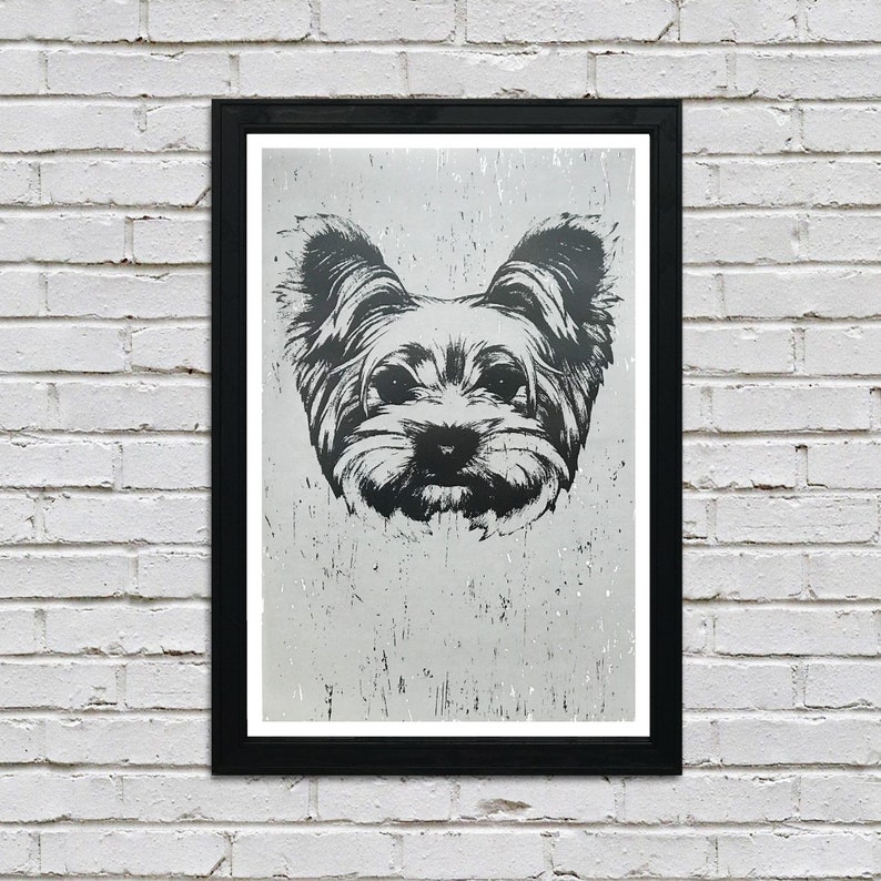 May include: Black and white illustration of a Yorkshire Terrier dog's face, printed on a textured, silver background. The image is framed in a black frame.