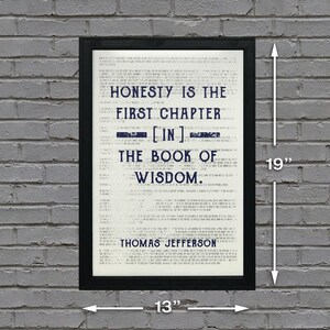 May include: A black framed print with a white background and blue text. The text reads "Honesty is the first chapter [in] the book of wisdom. Thomas Jefferson". The print measures 13 inches by 19 inches.
