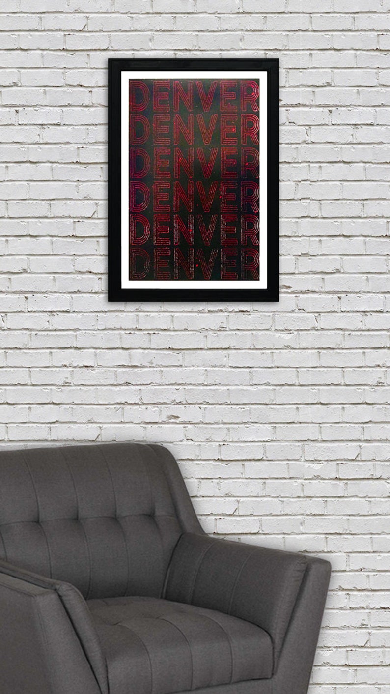 May include: A framed print with the word "DENVER" repeated multiple times in a red, outlined font on a black background.