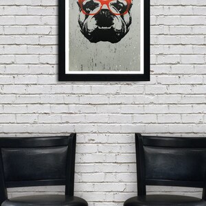 May include: A black and white illustration of a bulldog wearing red glasses, framed in a black frame and hanging on a white brick wall. Two black bar stools are in the foreground.