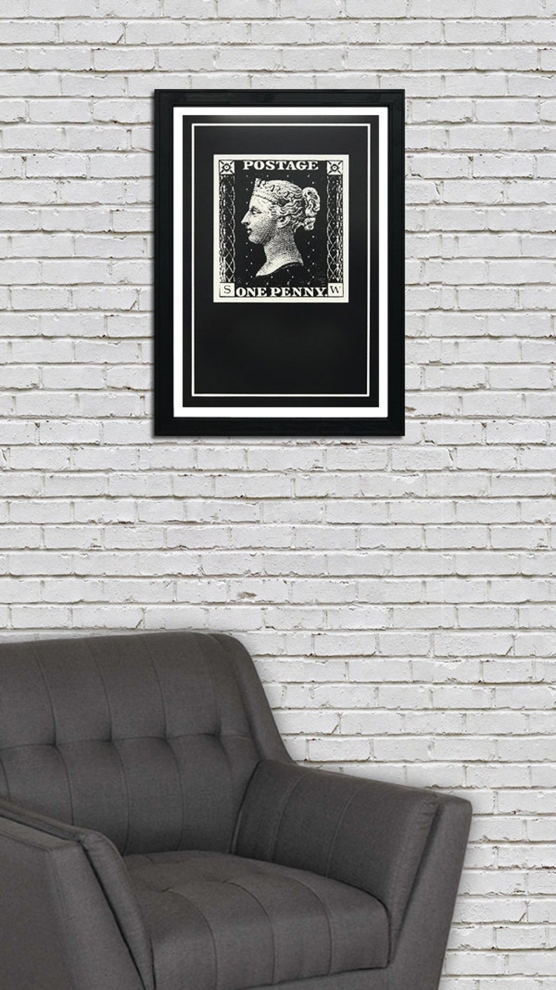 May include: A black and white framed print of a vintage postage stamp featuring a woman's profile and the text "POSTAGE ONE PENNY".