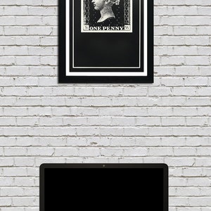 May include: A black and white framed print of a vintage postage stamp featuring a woman's profile and the text "POSTAGE ONE PENNY".